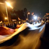 Anti-Mohamed Morsi protesters have clashed with police outside the presidential palace in Cairo, after a week of violence in which more than 60 people were killed