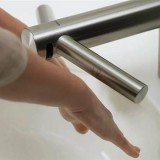 Dyson has unveiled Airblade Tap, a device that combines a high-speed hand dryer with hot and cold water outlets