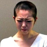 Minami Minegishi has shaved her head and offered a filmed apology after breaking her management firm's rules by spending a night with her boyfriend