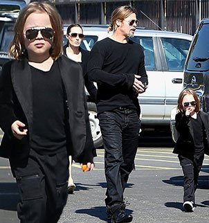 With golden shoulder length hair, a sophisticated black suit and aviator sunglasses, Knox Jolie-Pitt appears to be the spitting image of his famous father, Brad Pitt