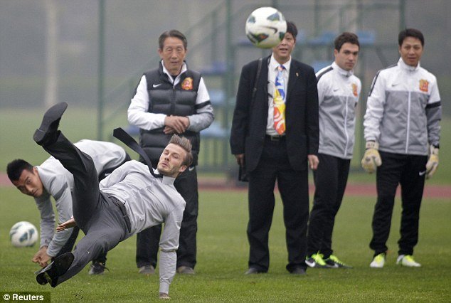 David Beckham slipped over and landed on his backside in front of a group of young Chinese footballers while demonstrating his free kick technique