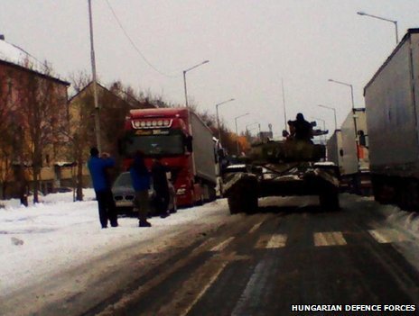 Hungary has deployed tanks to reach snowbound motorists as cold weather causes transport chaos across Eastern Europe