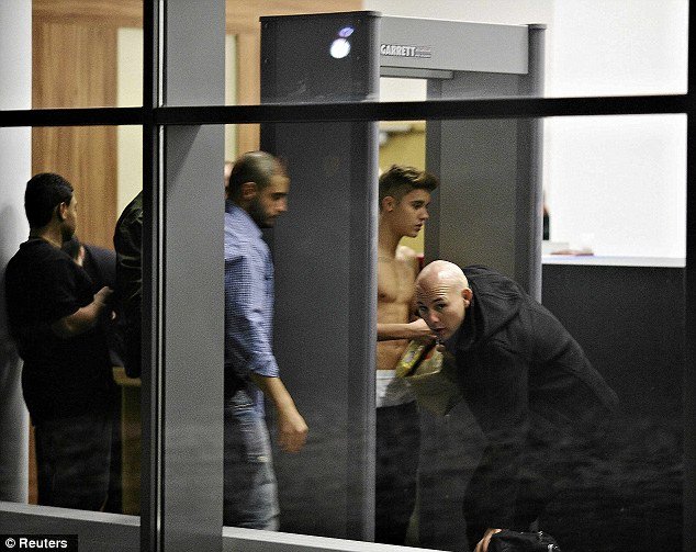 Justin Bieber was seen once again going shirtless as he stepped through a security gate at Wladyslaw Reymont Airport in Lodz, Poland