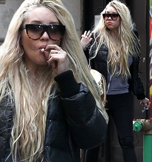 Amanda Bynes continued her bizarre behavior by openly smoking a suspicious-looking hand-rolled cigarette through Times Square
