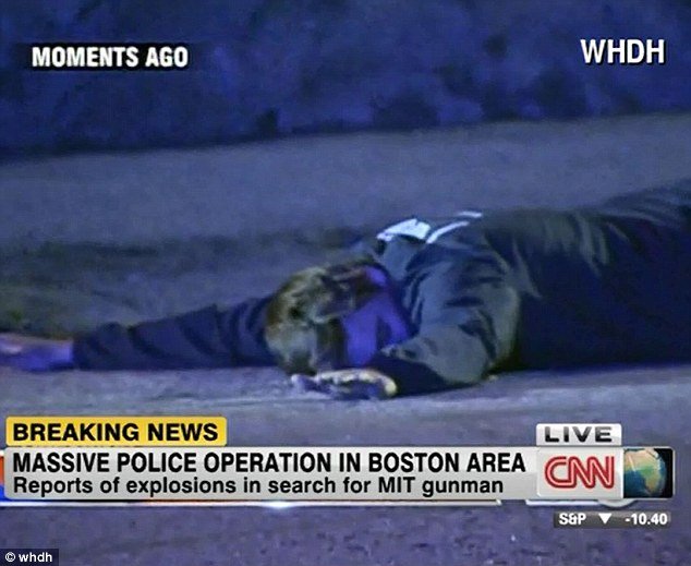 Boston police arrested a suspect at gunpoint after multiple shots and explosions were heard in the suburb of Watertown, hours after a MIT campus police officer was shot dead