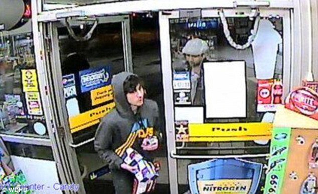 Dzhokhar Tsarnaev enters a gas station in Cambridge, Massachusetts, wearing a gray hoodie and carrying snacks on Thursday evening