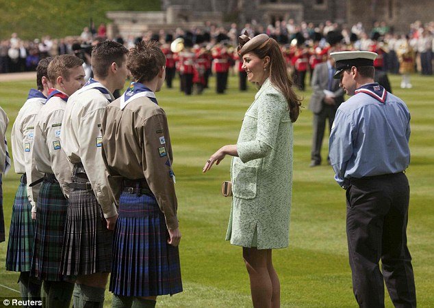 Kate Middleton, who is expecting her first baby in July, looked obviously pregnant for the first time as she attended the National Review of the Queen's Scouts at Windsor Castle