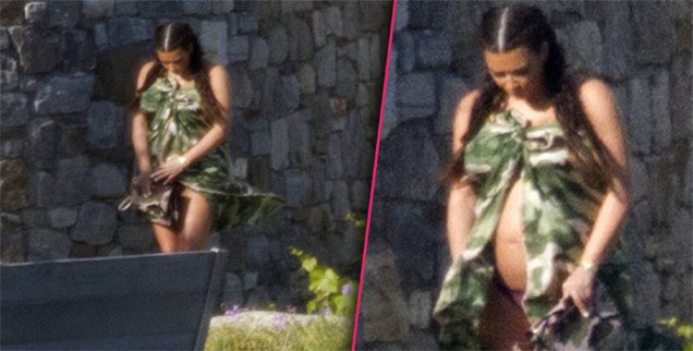 Kim Kardashian showed off a bare baby bump as she got time to relax with her family on holiday in Greece