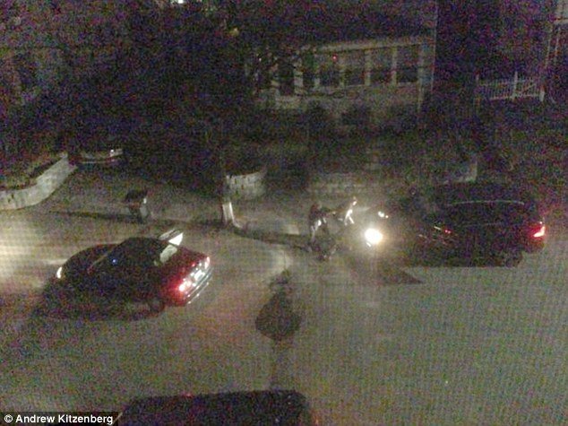 The images, taken by Andrew Kitzenberg, a resident of the Watertown street, in the early hours of Friday, show the Tsarnaev brothers sheltering behind a vehicle and clearly taking aim at police officers