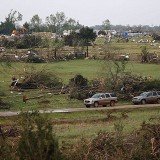 At least one person is reported dead and at least 21 others injured in a series of tornadoes that have torn through Oklahoma and Kansas.