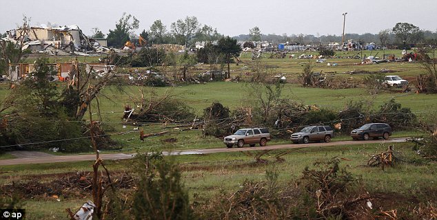 At least one person is reported dead and at least 21 others injured in a series of tornadoes that have torn through Oklahoma and Kansas.