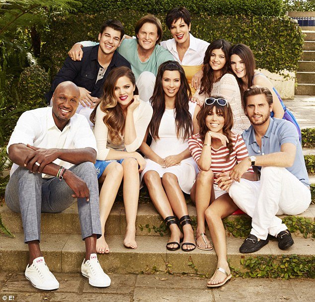 In the just-released family photo promoting the upcoming season of KUWTK, Khloe Kardashian is seated next to her husband Lamar Odom