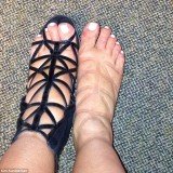 Kim Kardashian complained about her swollen feet when she tweeted a snap of them after wearing caged Givenchy boots all day