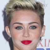 Miley Cyrus had a visible layer of white powder around her chin after suffering a make-up malfunction while glamming up to celebrate her title as Maxim's hottest woman