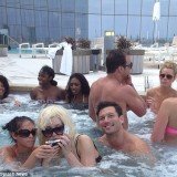 Amanda Bynes was pictured in a jacuzzi at the Revel Hotel where a few people gathered to get a photo, as she wore her trademark blonde wig