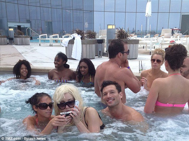 Amanda Bynes was pictured in a jacuzzi at the Revel Hotel where a few people gathered to get a photo, as she wore her trademark blonde wig