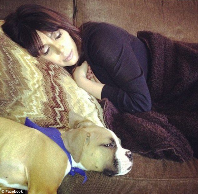 Kim Kardashian has shown up on Khloe's Facebook page looking exhausted and enjoying a nap with boxer pup Bernard