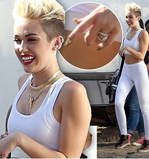 Miley Cyrus was very much displaying her 3.5 carat sparkler on the relevant engagement finger during a photo shoot in LA