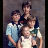 Oldest Robertson brother Alan, who isn't featured on the show, stands over his younger brothers Willie, Jep, and Jase