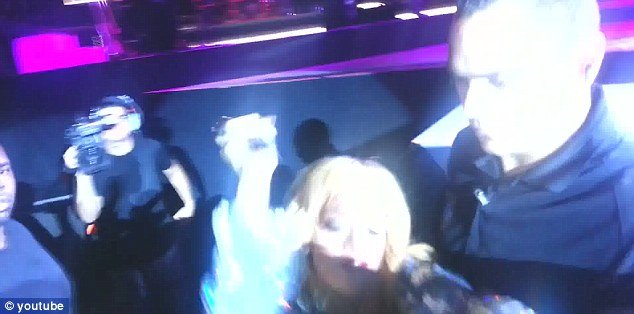 Rihanna has been caught on camera violently hitting an over eager fan in the face with her microphone during a recent concert in Birmingham
