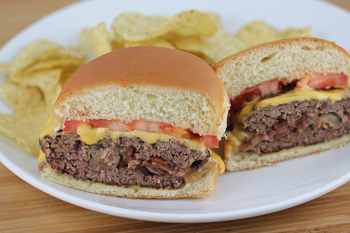 Cheeseburgers with bacon, onion and melted cheese for a tasty 4th of July celebration