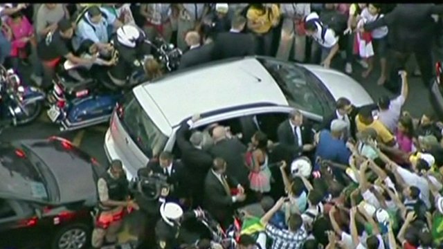 Crowds mobbed Pope Francis' car in Rio de Janeiro as it made its way from the airport