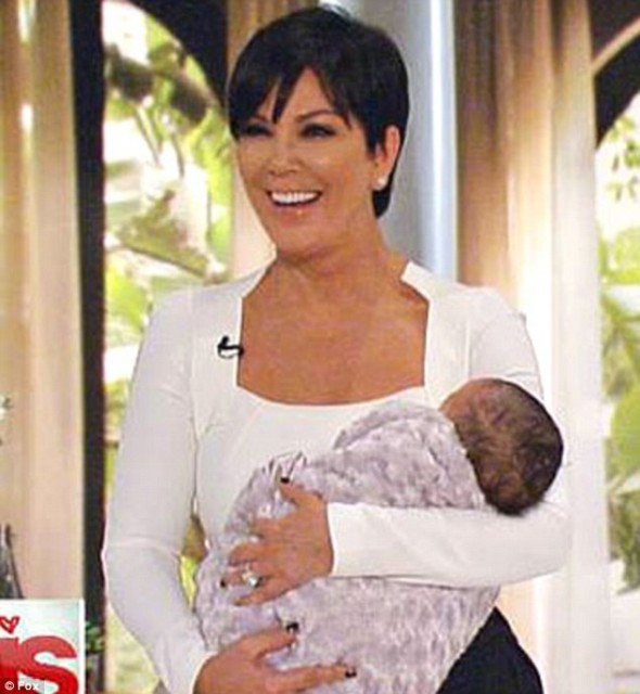 Kris Jenner tweeted a picture of her cradling a dark-haired baby just minutes before her show started