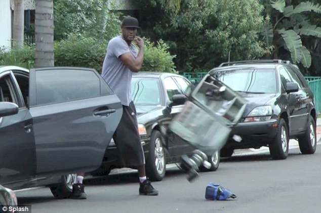 Lamar Odom lost his temper as he walked up to a photographer's car and threw all of his equipment out onto the street