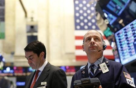 US shares closed at record levels after the Federal Reserve indicated that its efforts to boost the economy would continue for now