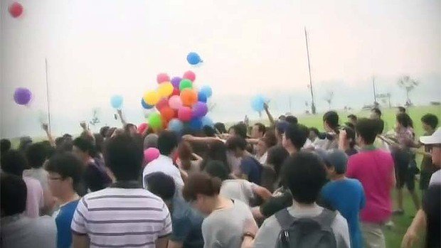 People arrived with BB guns and knives on sticks for a race to grab LG G2 smartphone vouchers hanging from helium balloons