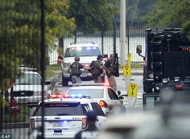 At least one heavily armed gunman opened fire inside a building at the Washington Navy Yard killing at least 11 people and injuring at least 12