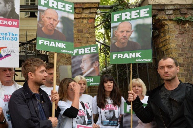 Jude Law and Damon Albarn have joined hundreds demonstrating in London over piracy charges brought by Russia against 30 Greenpeace activists