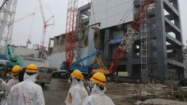 Stricken Fukushima nuclear plant has begun removing fuel rods from a storage pond at the Unit 4 reactor building