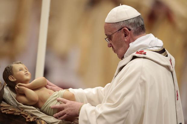 Before Christmas Eve Mass, Pope Francis personally placed a baby Jesus doll in a replica of a manger, a custom usually performed by an aid