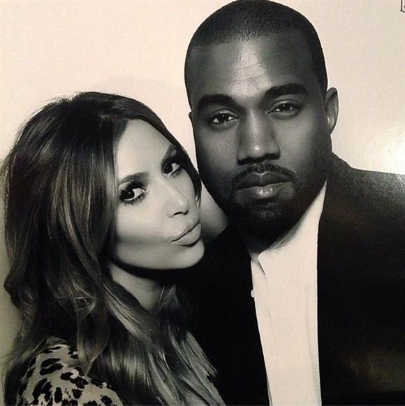 Kim Kardashian and Kanye West inside the "Naughty or Nice" photo booth