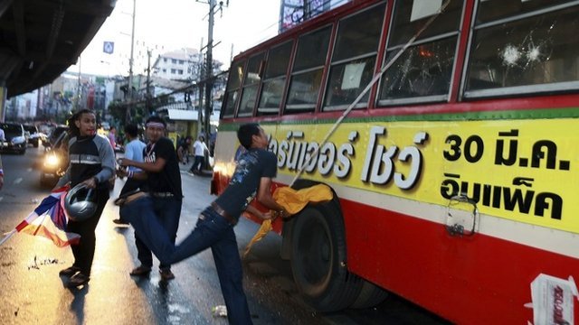 The worst violence occurred when Thai students attacked vehicles bringing pro-government activists to a Bangkok stadium