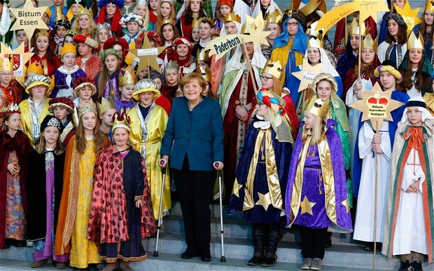 Angela Merkel has made her first public appearance since fracturing her pelvis in a skiing accident