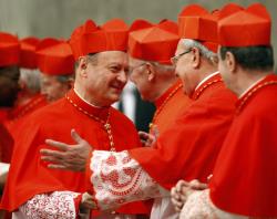 Cardinals wear red robes, along with scarlet zucchetto and biretta
