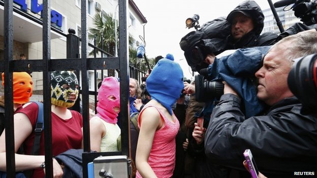 Pussy Riot members and two other women emerged from the police station in Sochi wearing their trademark ski masks after their brief detention