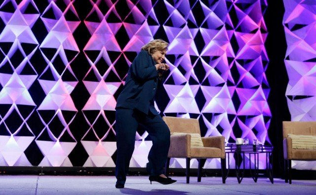 A woman was taken into custody after throwing what she said was a shoe at Hillary Clinton during a Las Vegas speech
