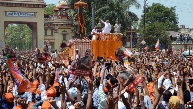 Narendra Modi arrived in the holy city of Varanasi as supporters from BJP poured onto the streets