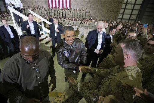 Barack Obama was cheered by soldiers during a surprise visit to Bagram Airfield outside Kabul