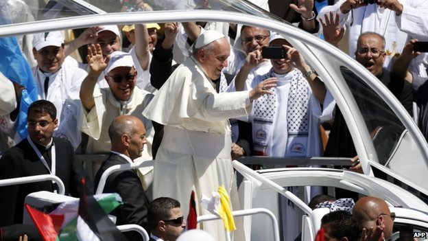 Pope Francis is holding an open-air mass for 8,000 local Christians by Bethlehem's Church of the Nativity