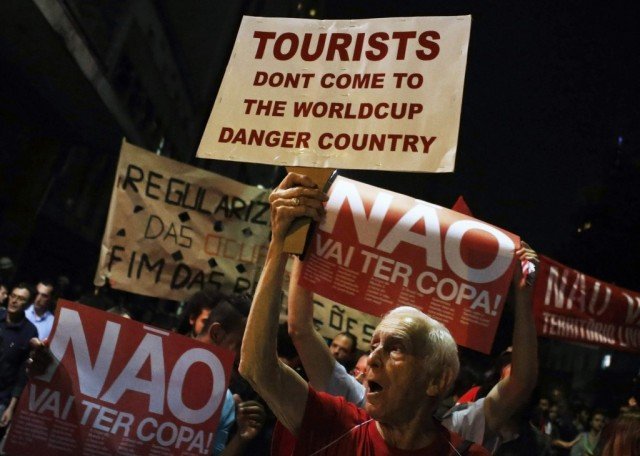 Thousands of protesters in Sao Paulo and Rio de Janeiro marched against the cost of hosting the football World Cup in Brazil