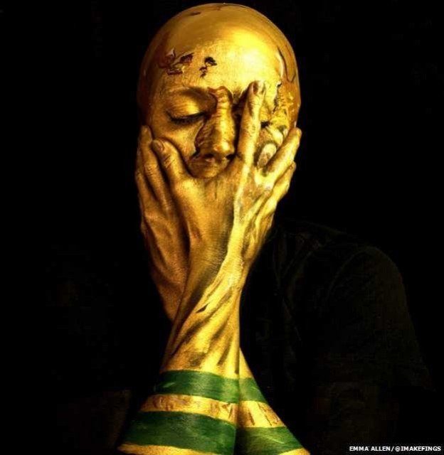 Emma Allen has used face paint to turn herself into the FIFA World Cup Trophy