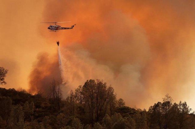 Two fast-moving wildfires in California are threatening homes and could result in the evacuation of hundreds of people