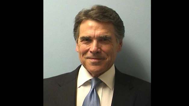 Showing no hint of worry on his face, Rick Perry flashed a thin, confident grin beneath perfect hair in his mug shot