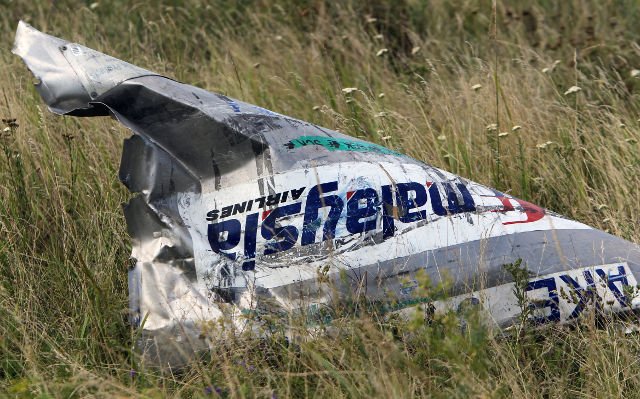 Malaysia Airlines flight MH17 broke up in mid-air after being hit by numerous objects that pierced the plane at high speed